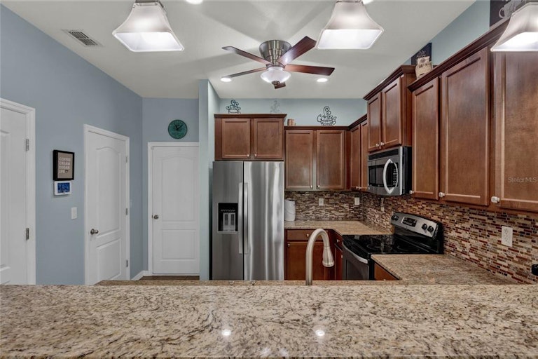 Photo 3 of 36 - 1033 Wood Cv, Kissimmee, FL 34743